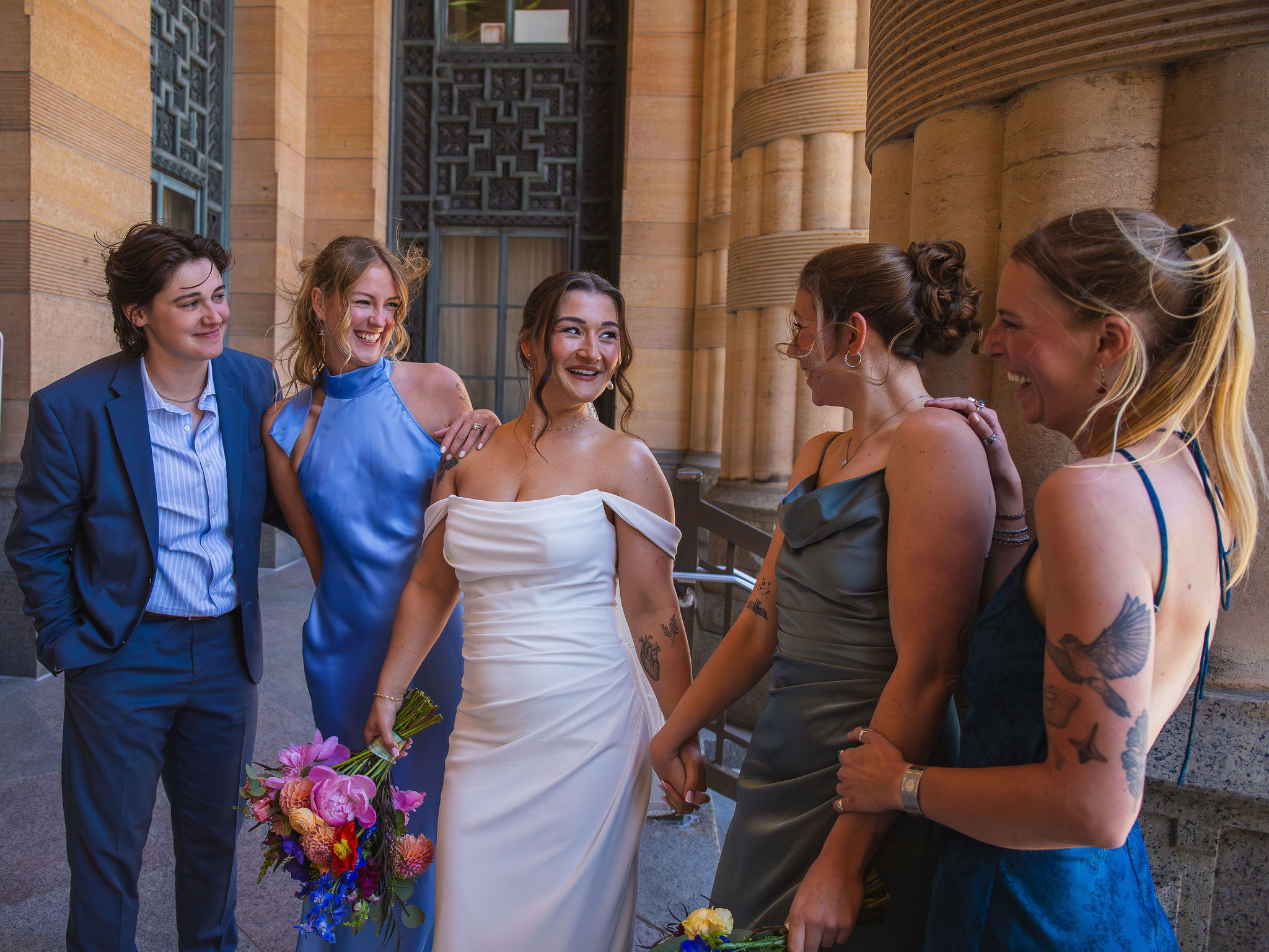 Gabrielle laughing with her bridal party outside Buffalo City Hall