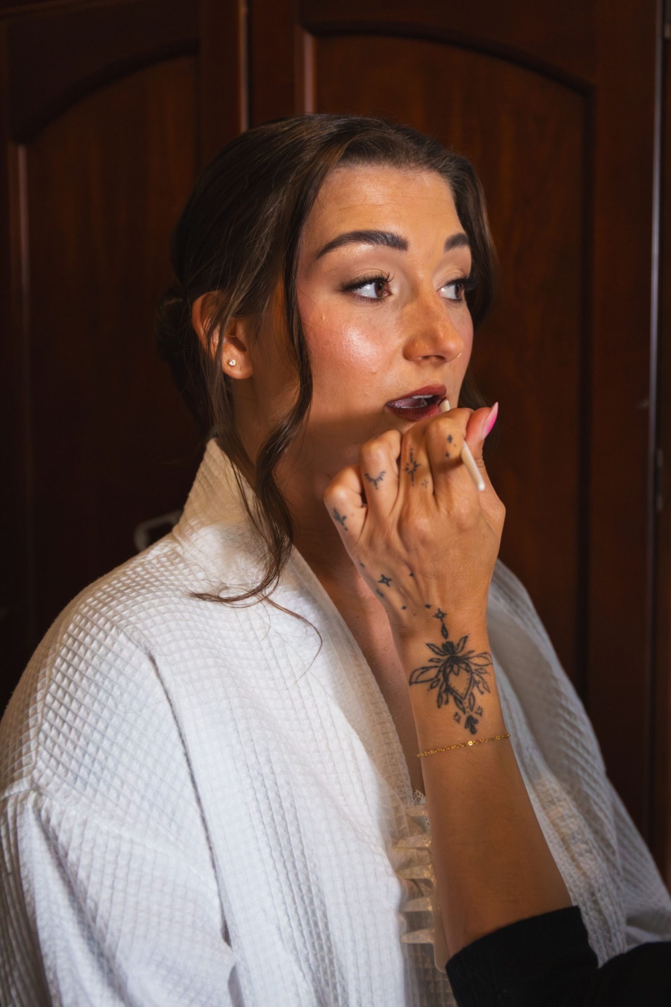 Gabrielle getting her lipstick touched up while getting ready