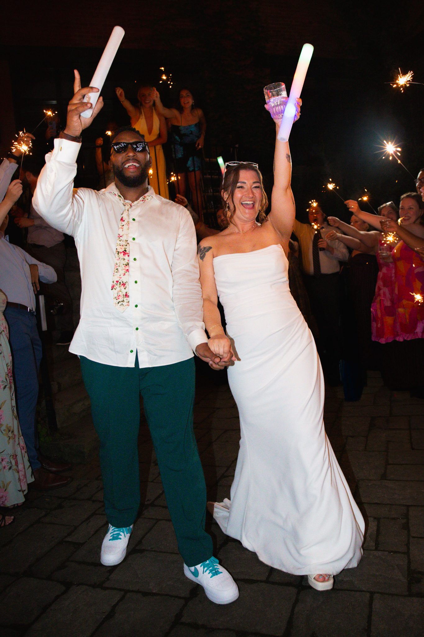 Bride and groom celebrating with sparklers at their wedding send-off